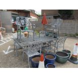 A metal garden table and eight chairs