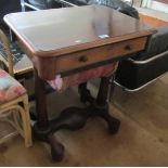 A Victorian mahogany sewing table with basket under and twin column supports