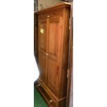A pine two door wardrobe with drawer