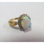 An opal and diamond cluster ring marked 15