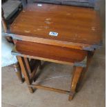 A nest of three occasional tables with brass corners.