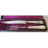 A French carving knife and fork with white metal handles marked Paris (boxed)