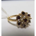 An 18ct gold ring set cluster of red and white stones