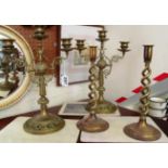 A pair of brass three branch candelabra and a pair of wrythen twist candlesticks