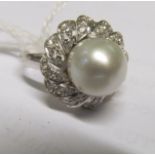 An 18k white gold pearl and diamond cluster dress ring