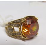 An 18k gold yellow stone and diamond dress ring