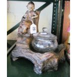 An Austrian pottery stand girl seated on a tree trunk with matched glass powder bowl