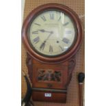 A Victorian wall clock with pierced glass window revealing pendulum the dial inscribed Geo E.