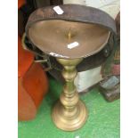 A brass stand and leather collar