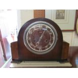 A 1930s arch top mantel clock