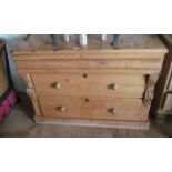 A pine chest of three drawers