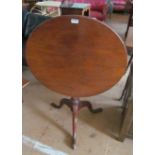 A mahogany tilt top table