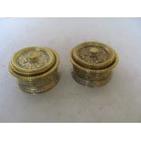 A pair of cast brass lidded boxes with liners