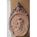 An oval terracotta garden plaque