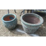 A stepped blue garden pot and another pot