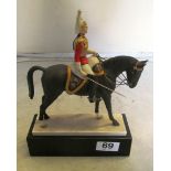 A Royal Worcester military equestrian figure 'The Lifeguards' by Doris Lindner supported in