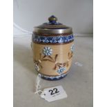 A Doulton Lambeth stoneware tobacco jar decorated raised blue flowers with silver rim
