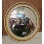A cream circular convex mirror