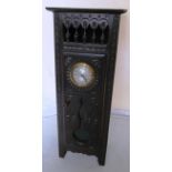 A small French oak cabinet in the form of a longcase clock