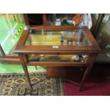 An Edwardian vitrine table on tapered supports