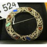 A Scottish style silver and marcasite circular brooch set coloured stones (one stone missing)
