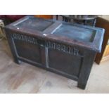 An 18th Century oak blanket chest with panelled front and sides and an ogee moulded frieze