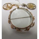 A gold frame brooch and two small frame pendants