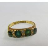 An 18ct gold green four stone ring