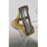 A gold and aquamarine rectangular shaped dress ring