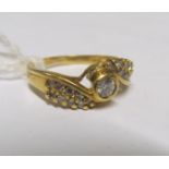 A gold crossover diamond ring