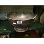A large silver plated punch bowl with lion ring handles