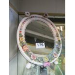 An oval porcelain framed mirror applied flowers (sa/f)