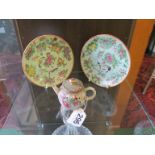 A small famille rose teapot and two butterfly decorated saucers