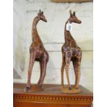 Two carved wood giraffe ornaments