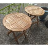 A pair of teak folding garden tables