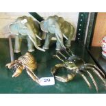 Two green painted metal elephants and two brass crabs