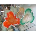 A set of three Murano glass shaped edge dishes green, orange and brown on white ground