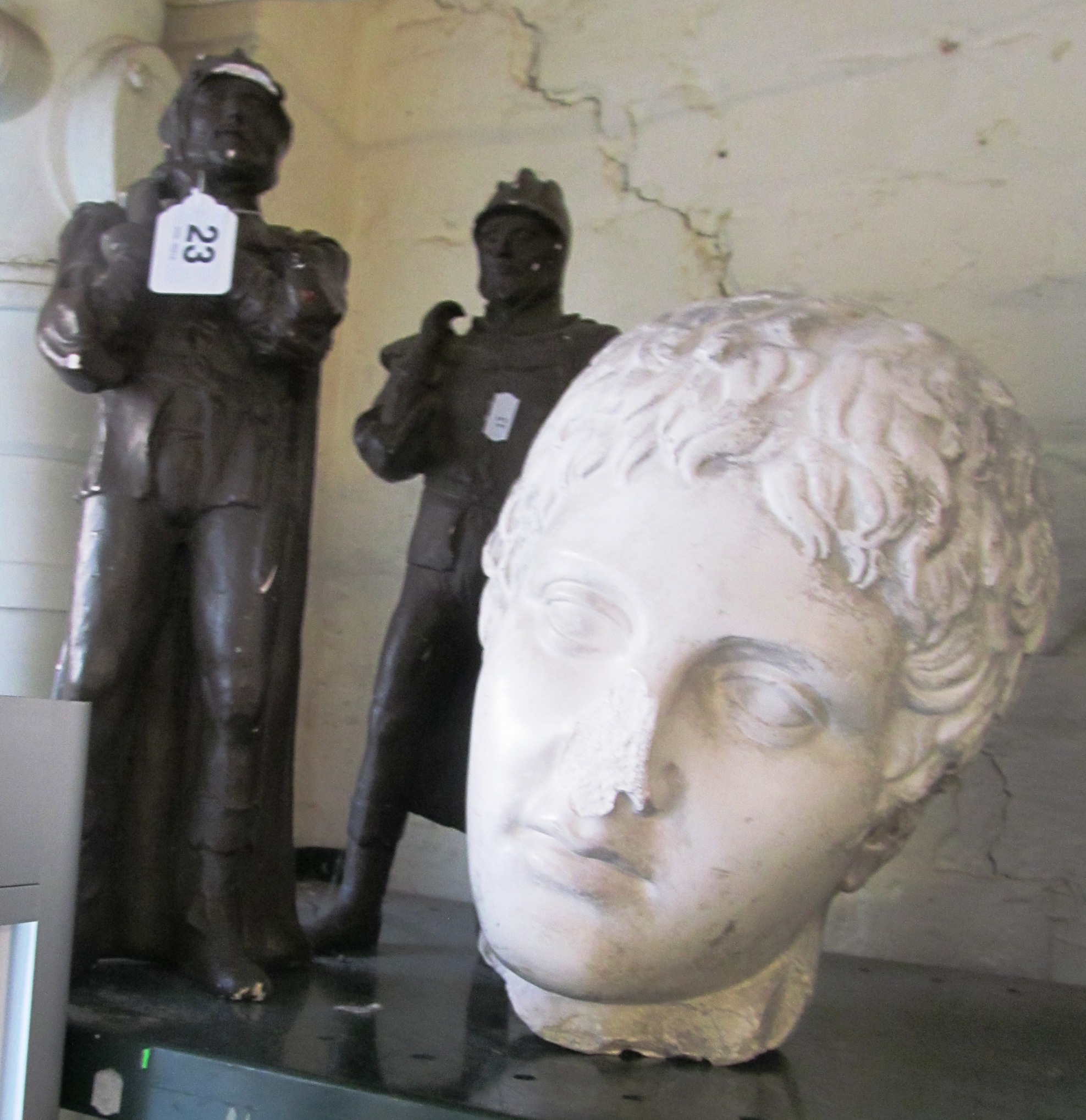 A pair of heraldic plaster figures and a Roman style plaster head (a/f)