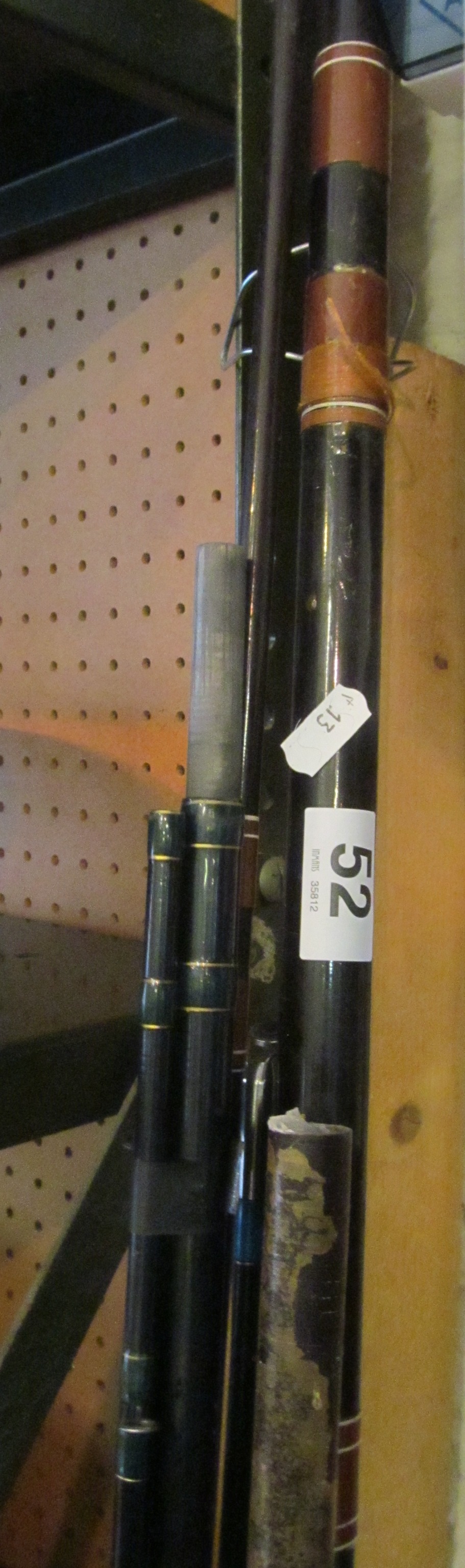 Various fishing rods and two vintage tennis racquets