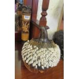 An African horned mask, shell shaker, carved container and a leather topped and cane stool