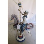A Lladro boy riding on a carousel horse No1470 (boxed)