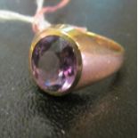 A gold signet ring set purple stone