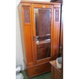 An Edwardian satin walnut mirror door wardrobe