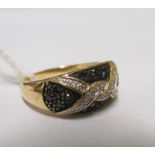 A 14ct gold ring set knot design of diamonds and black stones