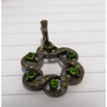 An Edwardian silver pendant set green and white stones