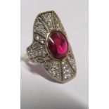 A diamond (marked .85ct) and red stone dress ring