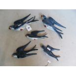 A set of five ceramic swallow wall plaques