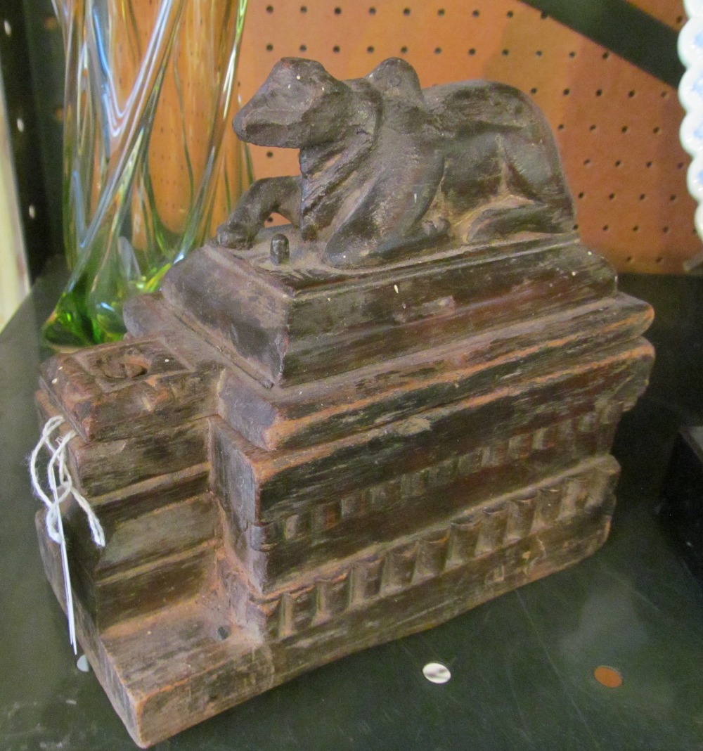 An Argentinian carved box with bullock to swivel lid