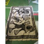 An antique bedspread and African panel