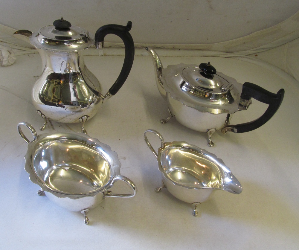 A silver (Sheffield 1931) three-piece teaset, the teapot and hot water jug with ebony knops and